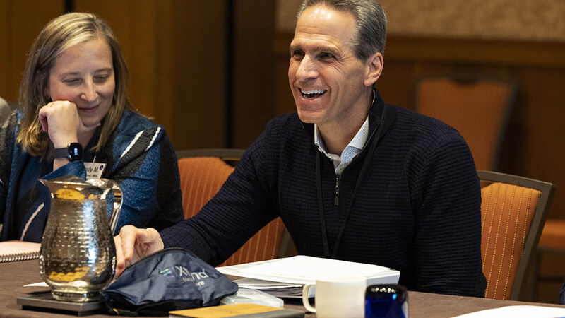 Two CEO Exchange attendees laughing during a session