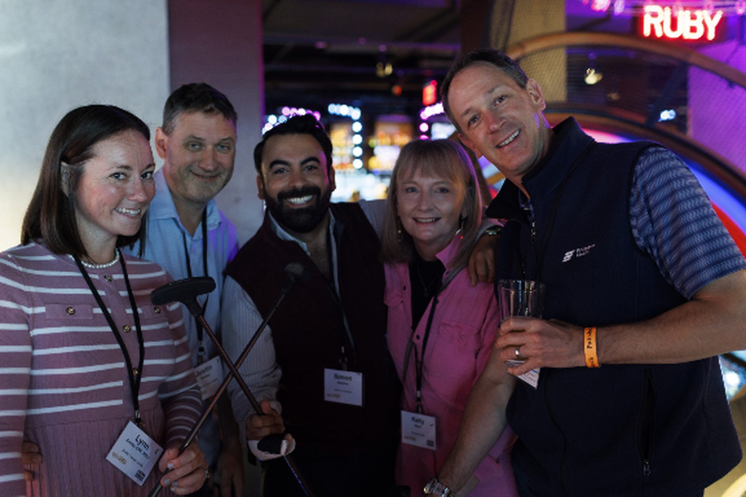 HealthLeaders Exchange members smiling together at an evening reception