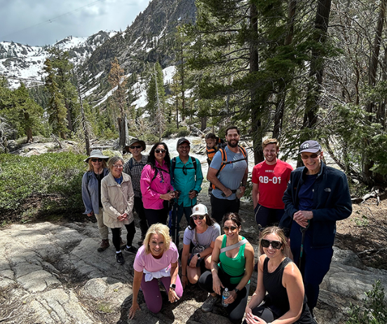 HealthLeaders Exchange members posing together on a mountain hiking trail