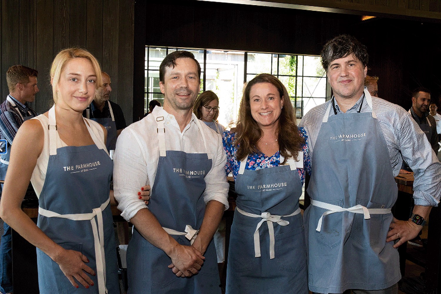 HealthLeaders Exchange members gathered together in Farmhouse aprons at an event
